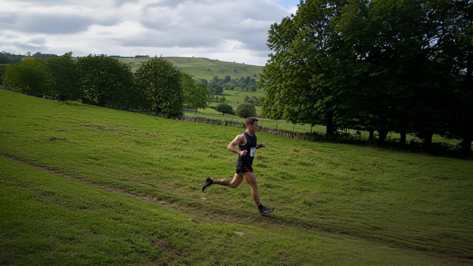 Fell runner crossing open Yorkshire countryside