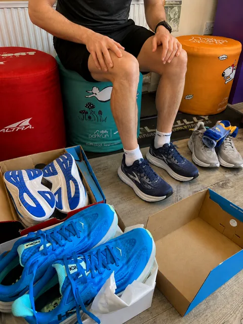 Customer comparing several pairs of running shoes during a Yorkshire Runner fitting